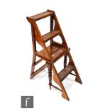 A Victorian oak Gothic revival metamorphic library chair, with rail back and turned front legs and