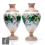 A pair of 19th Century Kerr and Binns Worcester pedestal vases each decorated in the round with a
