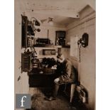 A black and white photograph showing a radio operator onboard a ship with Marconi equipment, the