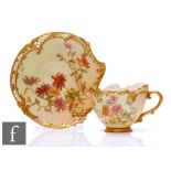 A Royal Worcester shape 1471 Empress blush ivory teacup and saucer decorated with sprays of