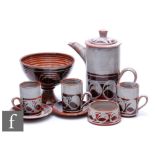 A Torquil Pottery tete a tete coffee set comprising a coffee pot, two cups and saucers, a sugar bowl