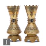 A pair of Gothic revival ecclesiastical brass vases in the manner of Pugin, of waisted footed form