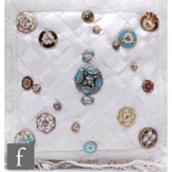 Twenty one assorted 19th Century buttons all with floral enamel detailing, affixed to a frilly