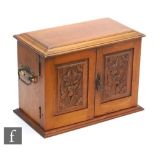 An early 20th Century oak smoker's cabinet, fitted with a drawer interior with a tobacco jar and