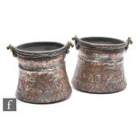 A pair of early 20th Century silvered copper cooking vessels, embossed with trailing leaves and
