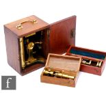 A 19th Century and later lacquered and brass painted microscope in mahogany case and two small brass