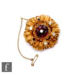 A 19th Century circular brooch set with garnets and paste set stones, weight 15g, diameter 40mm,