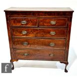 A George III inlaid mahogany straight front chest of two short and three long drawers on later