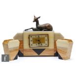 A 1930s French Art Deco three piece onyx and marble clock garniture, the clock surmounted by a