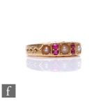 An early 20th Century seven stone ruby and split pearl ring, three pearls spaced by two pairs of