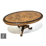 A small Victorian oval figured walnut occasional table on turned pedestal and floral carved scroll