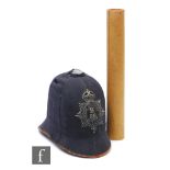 A blue cloth policeman's helmet, mounted with a badge for Bristol Constabulary B86 and a scroll