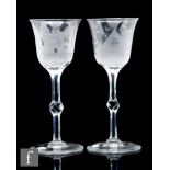 A pair of early 20th Century oversized clear crystal glass goblets, the ovoid bowls with everted rim