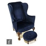A 20th Century George III style wing back and open arm easy chair, on shell carved claw and ball