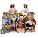 A collection of Staffordshire flatbacks and toby jugs, to include a French tin glazed faience