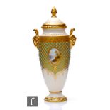 A Coalport twin handled pedestal vase decorated with a small hand painted cartouche of the waters