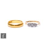 A 22ct hallmarked wedding ring, weight 4.3g, with an 18ct illusion set diamond three stone ring,