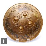 A Middle Eastern brass targe shield, profusely decorated with damascended detail and four