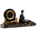 An Art Deco style French clock with a reclining girl and a pheasant, dial on black rectangular base,