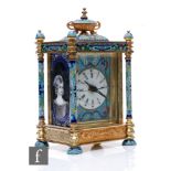 A late 20th Century French style champ leve enamel carriage clock, surmounted with an urn and oval