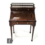 A later Victorian mahogany lady's writing desk, the gallery top over an interior fitted with a
