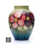 A Moorcroft Clematis pattern vase of tapered ovoid form, the graduated green ground, tubeline