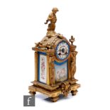 A 19th Century French gilt mantle clock, surmounted with a cherub over Sevres style panels and