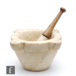 A 19th Century soft white marble pestle and mortar, turned pine handle, width 29cm.