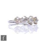 An 18ct white gold diamond four stone ring, claw set old cut stones, total weight approximately 1.