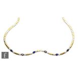 An 18ct yellow and white gold necklet detailed with six oval collar set sapphires each flanked