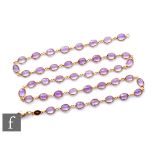 An 18ct hallmarked amethyst necklet comprising forty two oval individually set collar set stones