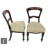 A set of six Victorian mahogany dining chairs with over-stuffed seats above turned and tapered front