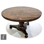 A William IV rosewood tilt-top breakfast table of circular form, raised to a baluster turned support