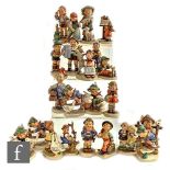 A collection of twenty-three Goebel Hummel figures, including Apple Tree Girl, Goose Girl, Merry