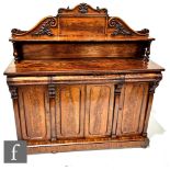 A Victorian mahogany chiffonier with acanthus carved upright pediment over three frieze drawers