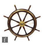A large 19th Century mahogany and brass ships wheel with central fixed boss