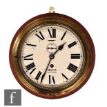 A 20th Century brass bulk head Smiths Astral clock mounted on a wooden base, key wind, 20cm dial.