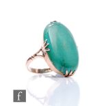 A 9ct single stone oval turquoise ring, claw set stone, length 30mm, to split shoulders, weight 7.