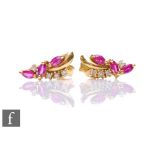A pair of 18ct hallmarked ruby and diamond stud earrings each with three marquise cut rubies