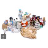 A collection of porcelain half dolls, candle snuffers and figures, to include a Royal Worcester
