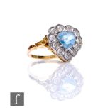 An 18ct aquamarine and diamond cluster ring, heart shaped cut aquamarine