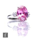 A 9ct hallmarked kunzite and cubic zirconia three stone ring, central oval kunzite flanked by a