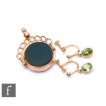 A 9ct hallmarked circular bloodstone swivel fob, Chester 1919, with a pair of peridot screw