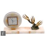 An Art Deco alabaster mantle clock, the circular movement set with a square dial and eight day