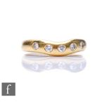 An 18ct hallmarked diamond five stone ring, gypsy set stones to a plain waved head, weight 5.8g,