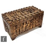An African hardwood linen or blanket chest, carved in deep relief with a procession of Benin style