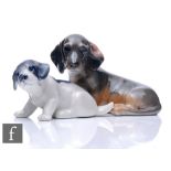 Two Royal Copenhagen dogs, the first a dachshund model 3140, the second a pointer puppy model