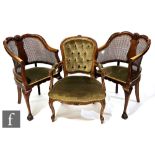 A pair of 1930s bergere cane back elbow chairs, the sweeping backs centred by a shell over a pale