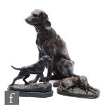A 20th Century bronze study of a seated dog, another after M Deva of a sleeping borzoi and a small