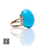 A 9ct hallmarked single stone turquoise ring, oval side claw set stone, length 18mm, all to a scroll